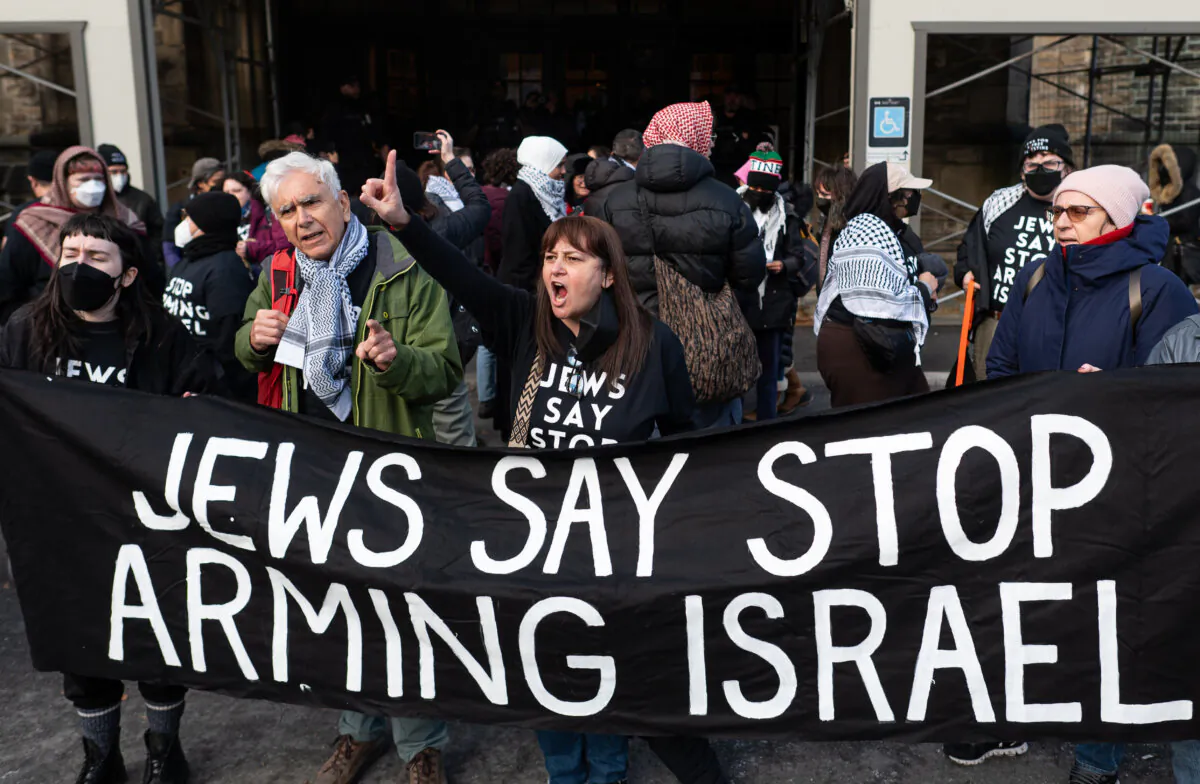 Pro-Palestinian protesters demonstrate outside of the Confederation Building near Parliament Hill during a sit-in styled protest calling for an arms embargo against Israel in Ottawa, on Dec. 3, 2024. THE CANADIAN PRESS/Spencer Colby