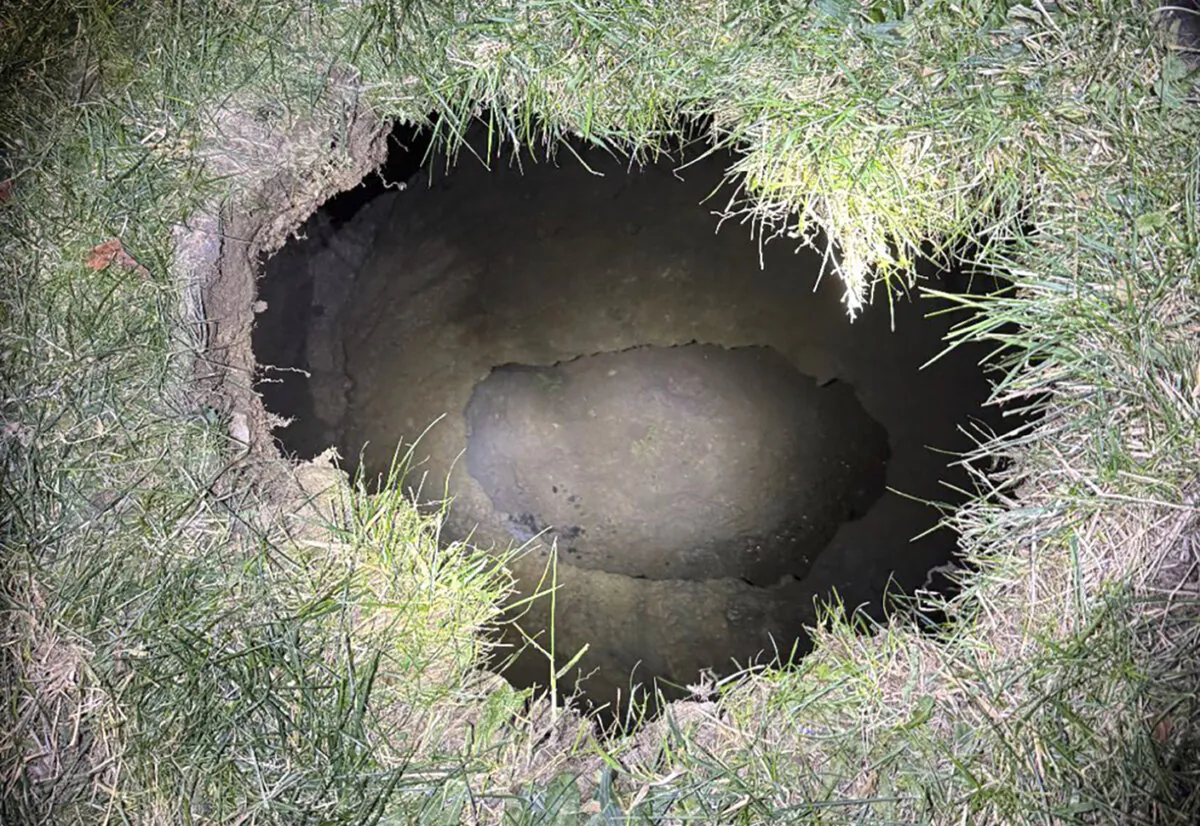 The top of a sinkhole on Dec. 3, 2024, in the village of Marguerite, Pa., where rescuers were searching for a woman who disappeared. (Pennsylvania State Police via AP)