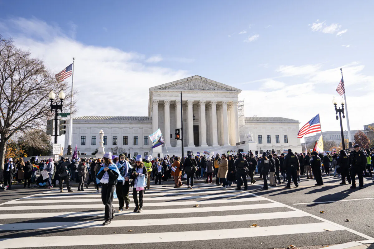 People protest as the Supreme Court hears arguments in a case involving bans on gender procedures for minors, in Washington on Dec. 4, 2024. (Madalina Vasiliu/The Epoch Times)