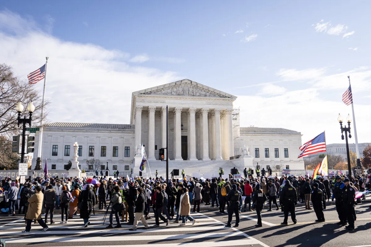 People protest as the Supreme Court hears case over banning gender procedures for minors in Washington on Dec. 4, 2024. (Madalina Vasiliu/The Epoch Times)