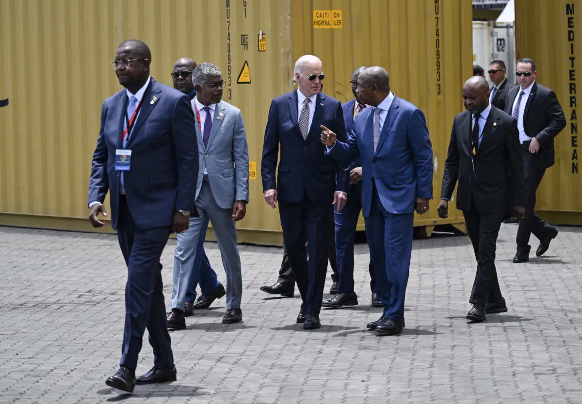 US President Joe Biden (CL) speaks with Angola President Joao Lourenco (CR) as they visit the Port in Lobito on December 4, 2024. (Photo by ANDREW CABALLERO-REYNOLDS / AFP)