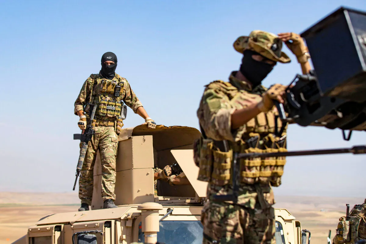 A fighter of the Syrian Democratic Forces (SDF) stands atop a Humvee in Syria's northeastern Hasakah province on Sept. 7, 2022. (Delil Souleiman/AFP via Getty Images)