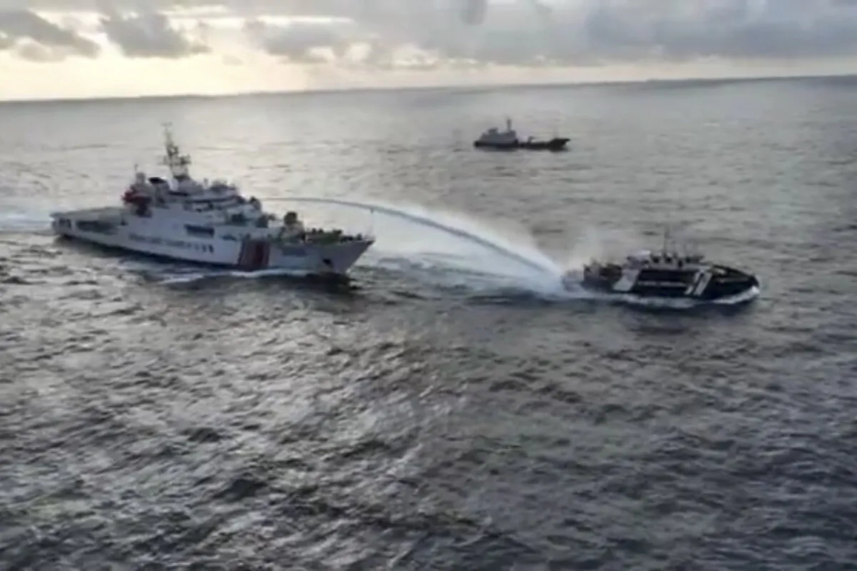 In this image made from a video provided by the National Task Force for the West Philippine Sea, a Chinese coast guard vessel, left, fires a powerful water cannon on a Philippine bureau of fisheries vessel near a disputed shoal in the South China Sea on Dec. 4, 2024. (National Task Force for the West Philippine Sea via AP)
