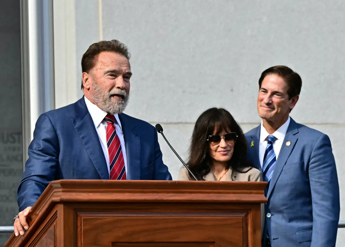Former California Gov. Arnold Schwarzenegger speaks before swearing in Nathan Hochman (R), with his wife Vivienne Vella, as Los Angeles district attorney outside of the Hall of Justice on Dec. 3, 2024. (Frederic J. Brown/AFP via Getty Images)