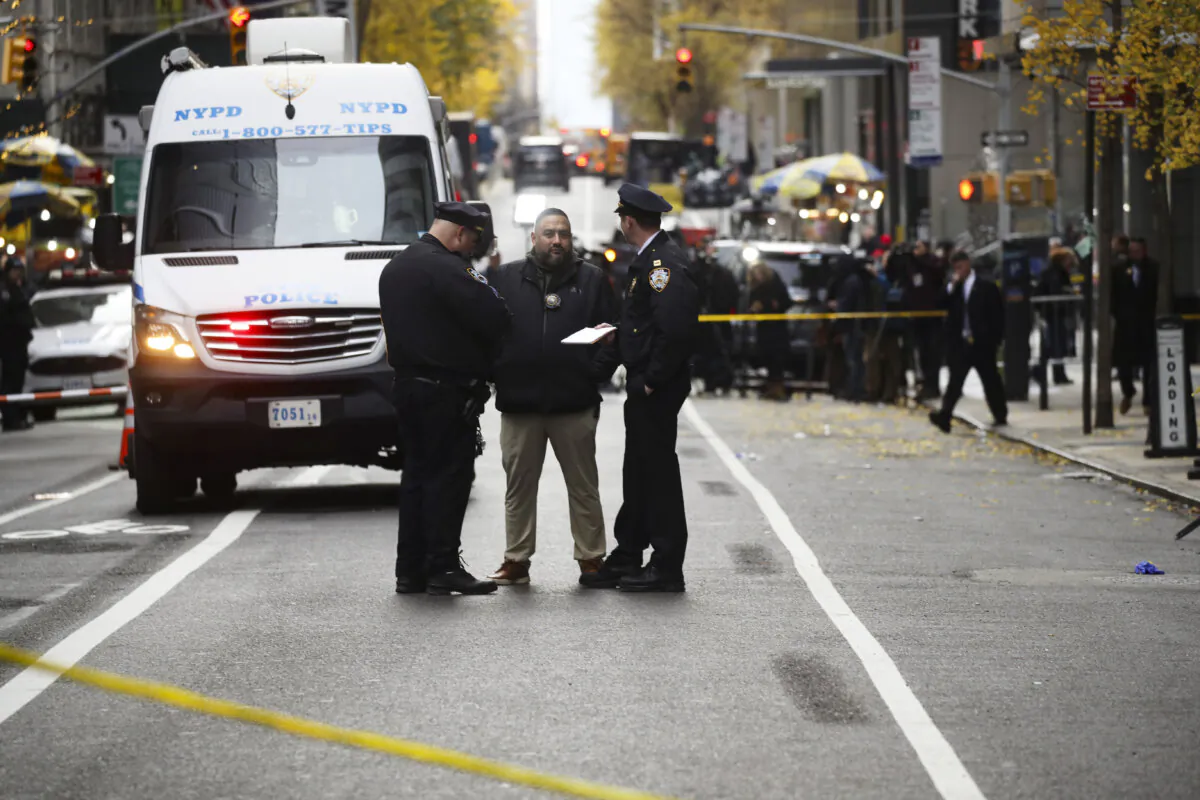 Police gather outside of a Hilton Hotel in Midtown Manhattan where United Healthcare CEO Brian Thompson was fatally shot in New York City on Dec. 4, 2024. (Spencer Platt/Getty Images)