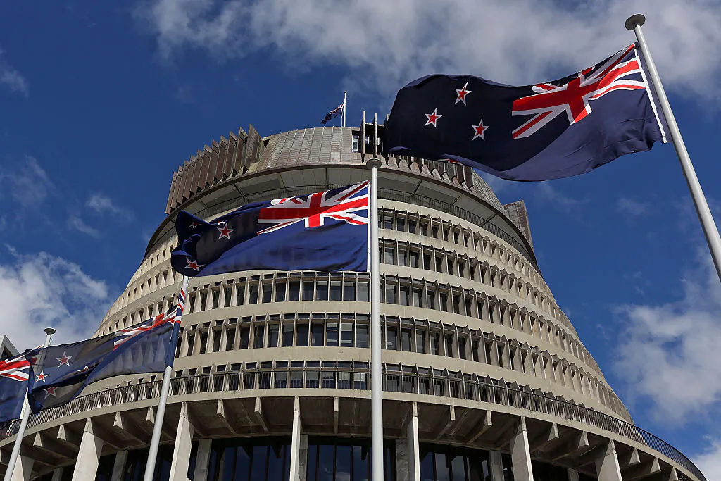 New Zealand flags fly in front of The Beehive during the Commission Opening of Parliament in Wellington, New Zealand, on Oct. 20, 2014. (Hagen Hopkins/Getty Images)
