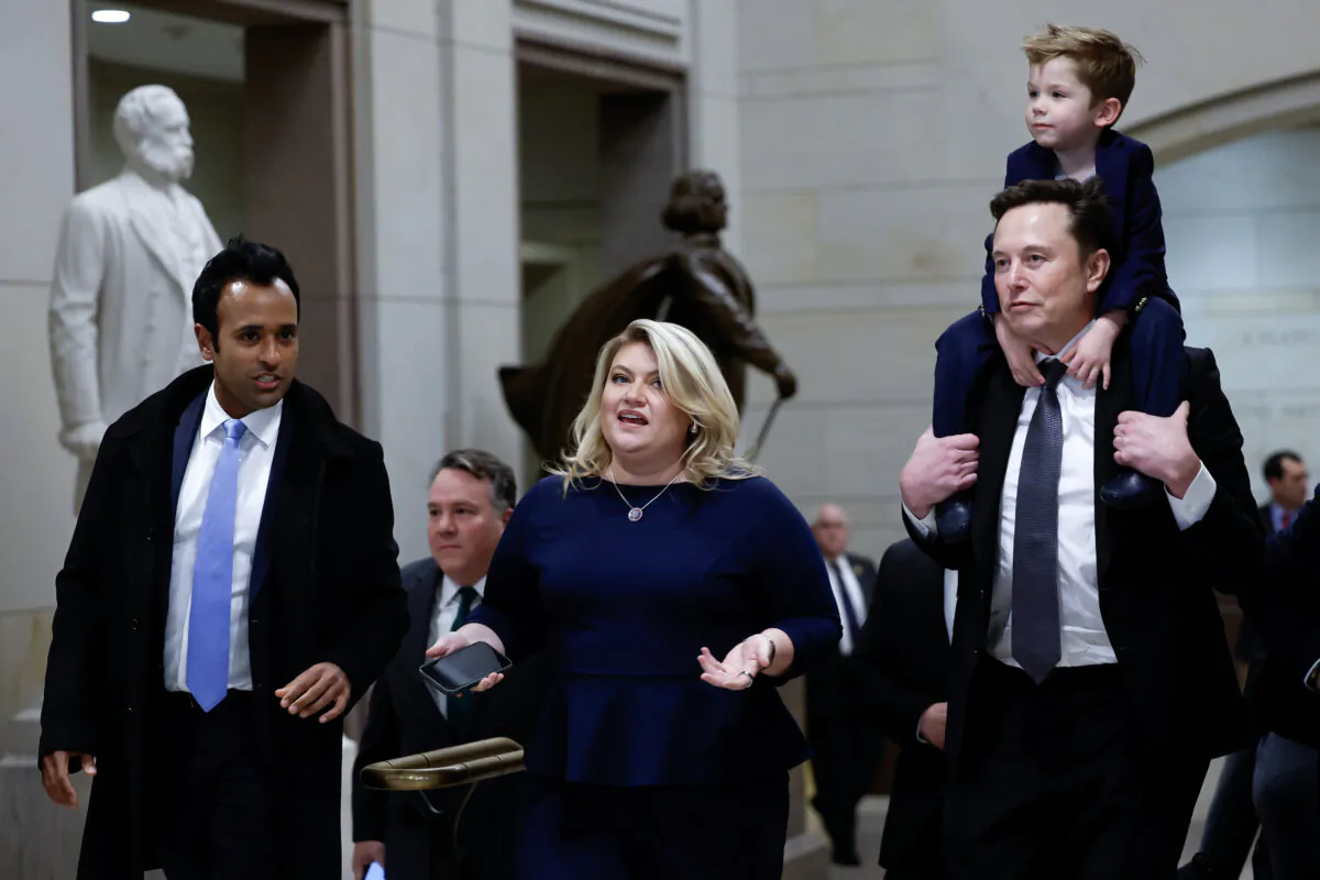 Tesla CEO Elon Musk (R), co-chair of the newly announced Department of Government Efficiency (DOGE), carries his son on his shoulders at the U.S. Capitol following a meeting with businessman Vivek Ramaswamy (L), co-chair of the newly announced Department of Government Efficiency, Rep. Kat Cammack (C), and other members of the U.S. Congress in Washington on Dec. 5, 2024. (Anna Moneymaker/Getty Images)