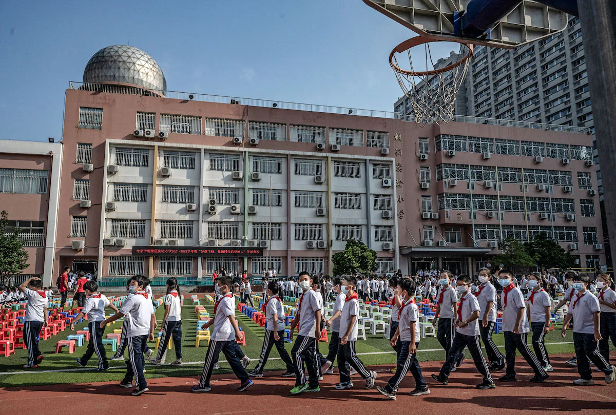 Students arrive for a ceremony on the first day of the new school year at an elementary school in Beijing, China, on Sept. 1, 2021. (Kevin Frayer/Getty Images)