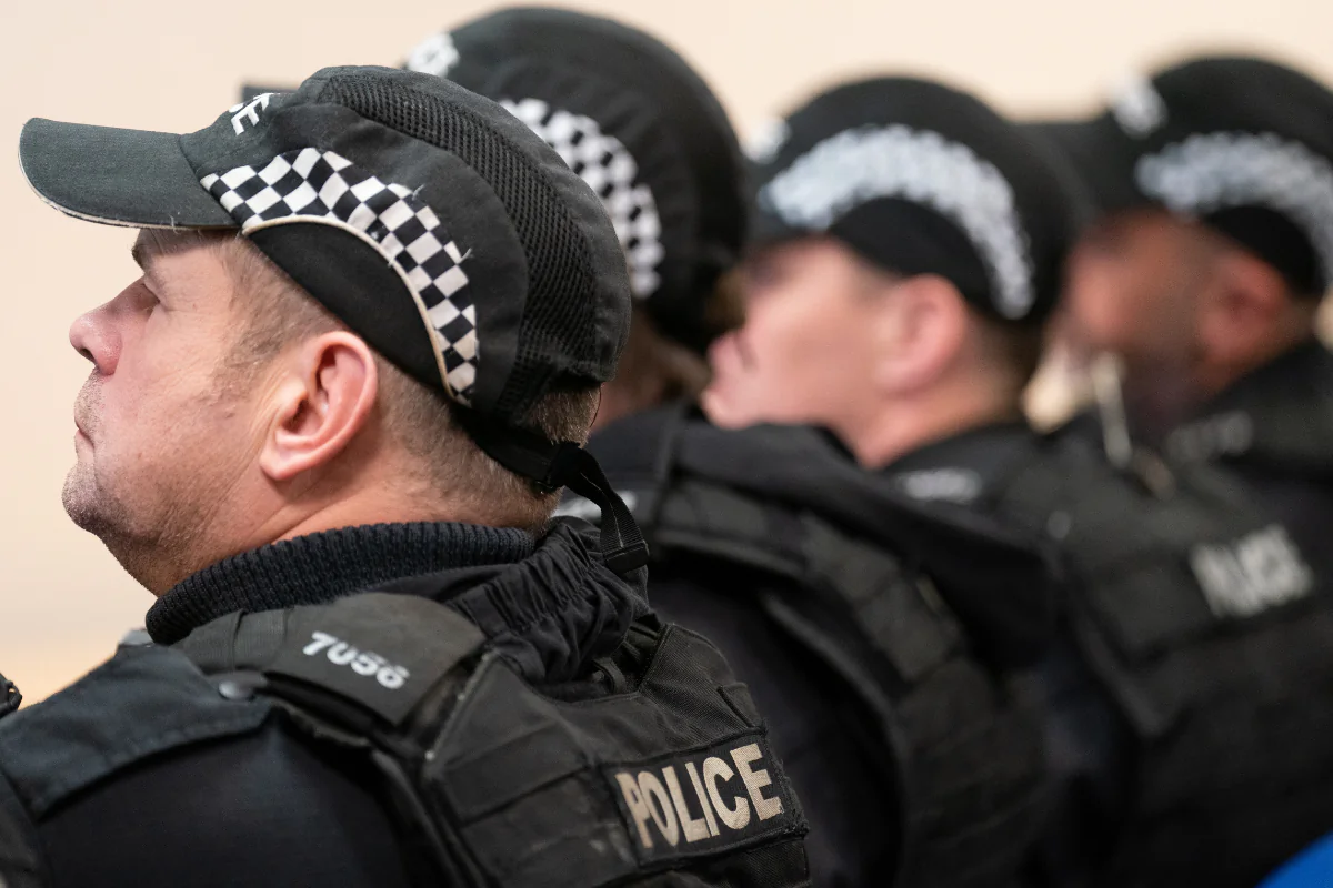 Officers from West Midlands Police attend a briefing before carrying out a County Lines raid in Coventry, England, on Oct. 11, 2023. (Joe Giddens/PA Wire)


