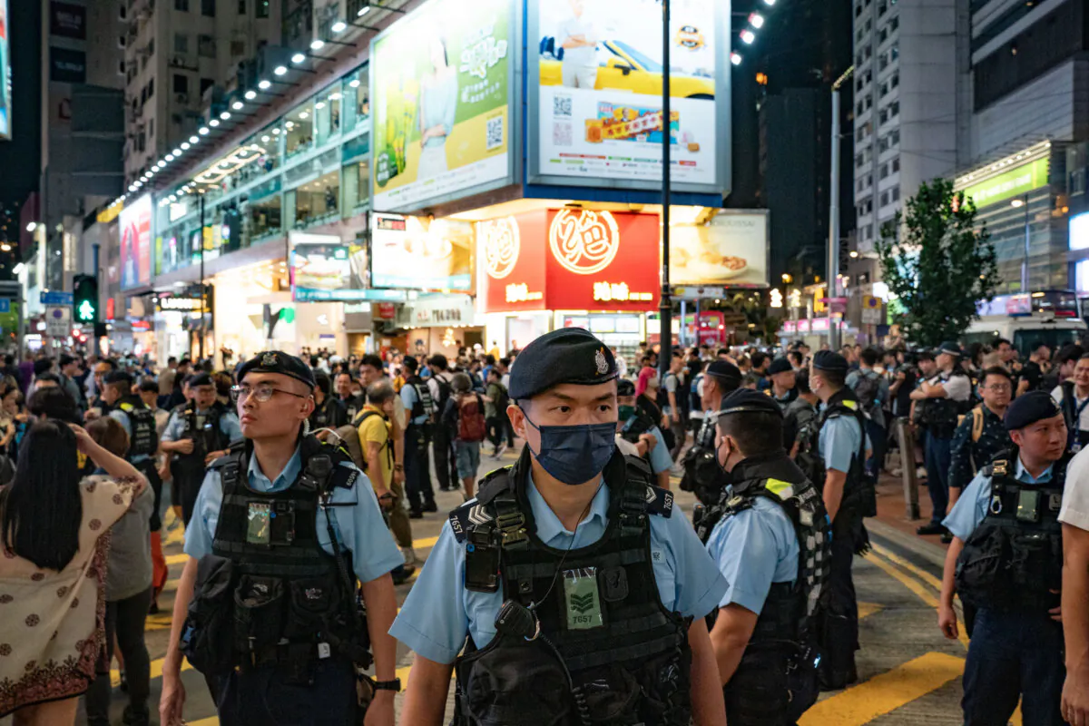 Police officers patrol at the Causeway Bay district near Victoria Park where people traditionally gathered annually to mourn the victims of China's Tiananmen Square massacre in 1989, in Hong Kong on June 4, 2024. (Anthony Kwan/Getty Images)