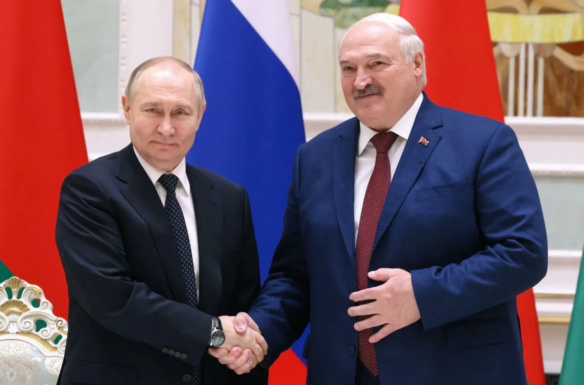 Russian President Vladimir Putin and his Belarusian counterpart Alexander Lukashenko shake hands during a press briefing following their talks in Minsk, Belarus, on May 24, 2024. (Mikhail Metzel/Sputnik/pool via Reuters)