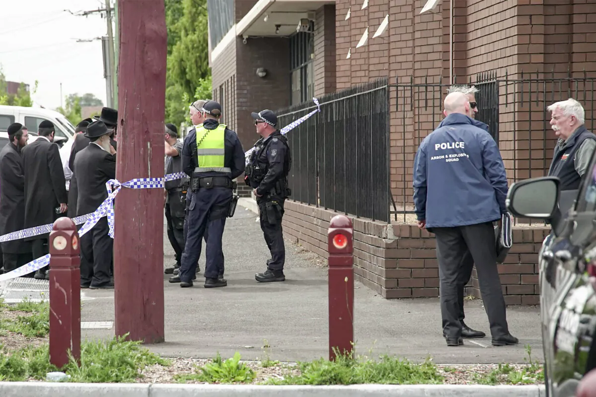 Police officers investigate near the scene of a fire at the Adass Israel Synagogue in Melbourne on Dec. 6, 2024. (Tania Lee/AFP via Getty Images)