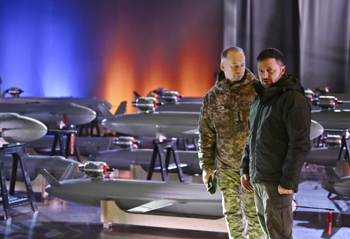 Ukrainian President Volodymyr Zelensky (R) and Commander-in-Chief of the Armed Forces of Ukraine Oleksandr Syrsky (L) speak next to the first batch of Ukrainian-made drone missiles "Peklo" (Hell) delivered to the Defence Forces of Ukraine in Kyiv on Dec. 6, 2024. Genya Savilov/AFP via Getty Images)