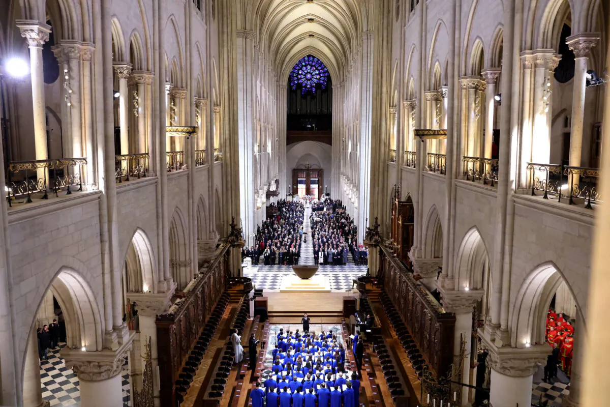 The choir, clergy, and guests stand during the ceremony to mark the reopening of Notre-Dame of Paris Cathedral in Paris on Dec. 7, 2024. (Pascal Le Segretain/Getty Images for Notre-Dame de Paris)