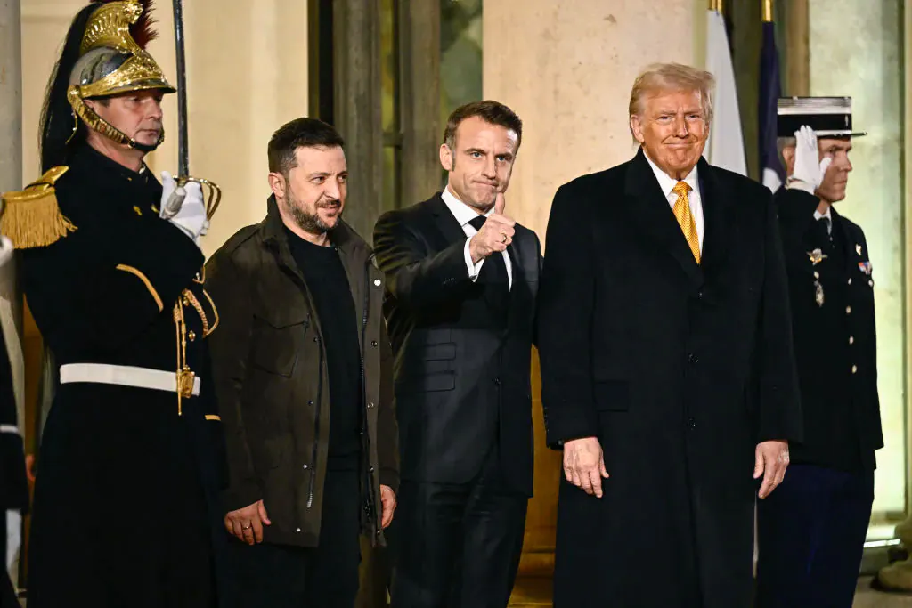 France's President Emmanuel Macron (C) thumbs up flanked by U.S. president-elect Donald Trump (R) and Ukraine's President Volodymyr Zelenskyy (2nd L) after a meeting at The Elysee Presidential Palace in Paris on Dec. 7, 2024. (Julien de Rosa/AFP via Getty Images)