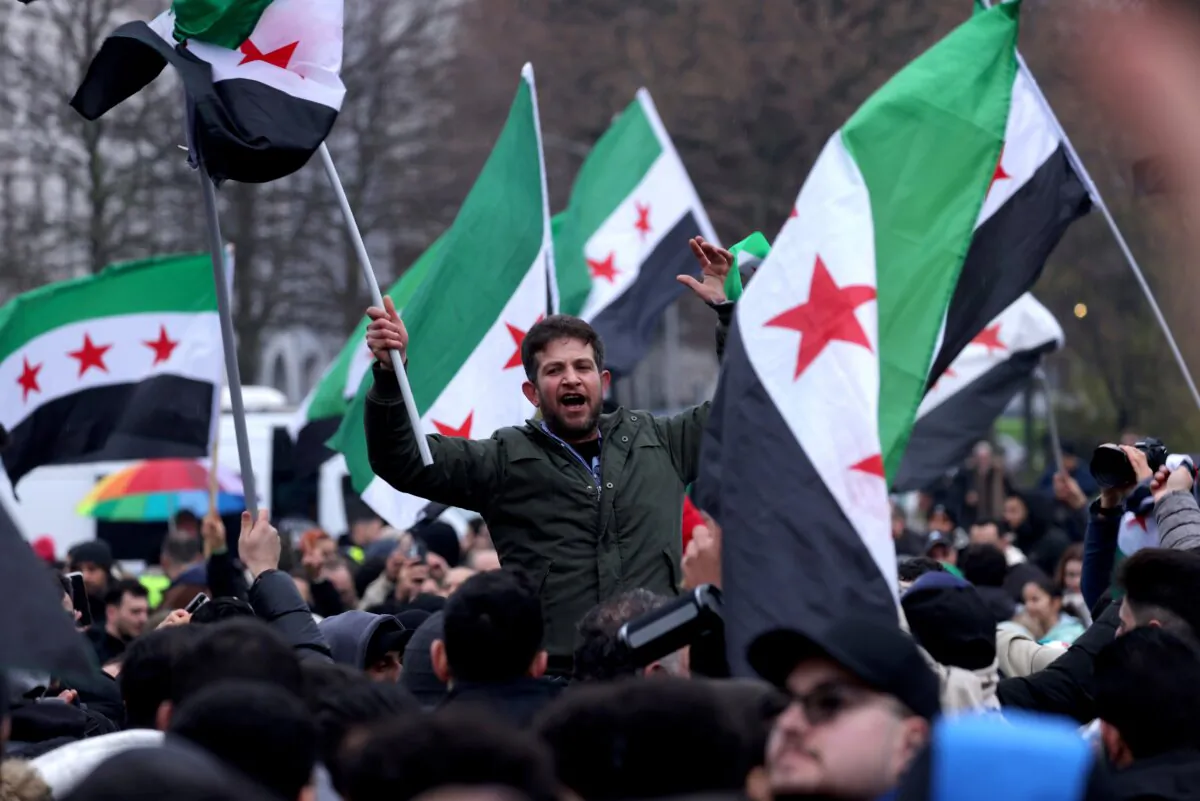 Expatriate Syrians gather to celebrate the fall of the Assad regime in Syria, in Berlin, Germany, on Dec. 8, 2024. (Sean Gallup/Getty Images)