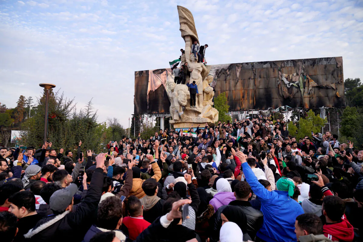 People gather at Saadallah al-Jabiri Square as they celebrate in Aleppo, Syria, on Dec. 8, 2024. REUTERS/Karam al-Masri
