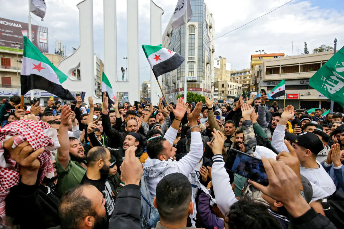 Syrian and Lebanese people celebrate the fall of the Syrian regime, in the northern Lebanese city of Tripoli, on Dec. 8, 2024. (Ibrahim Chalhoub/AFP via Getty Images)