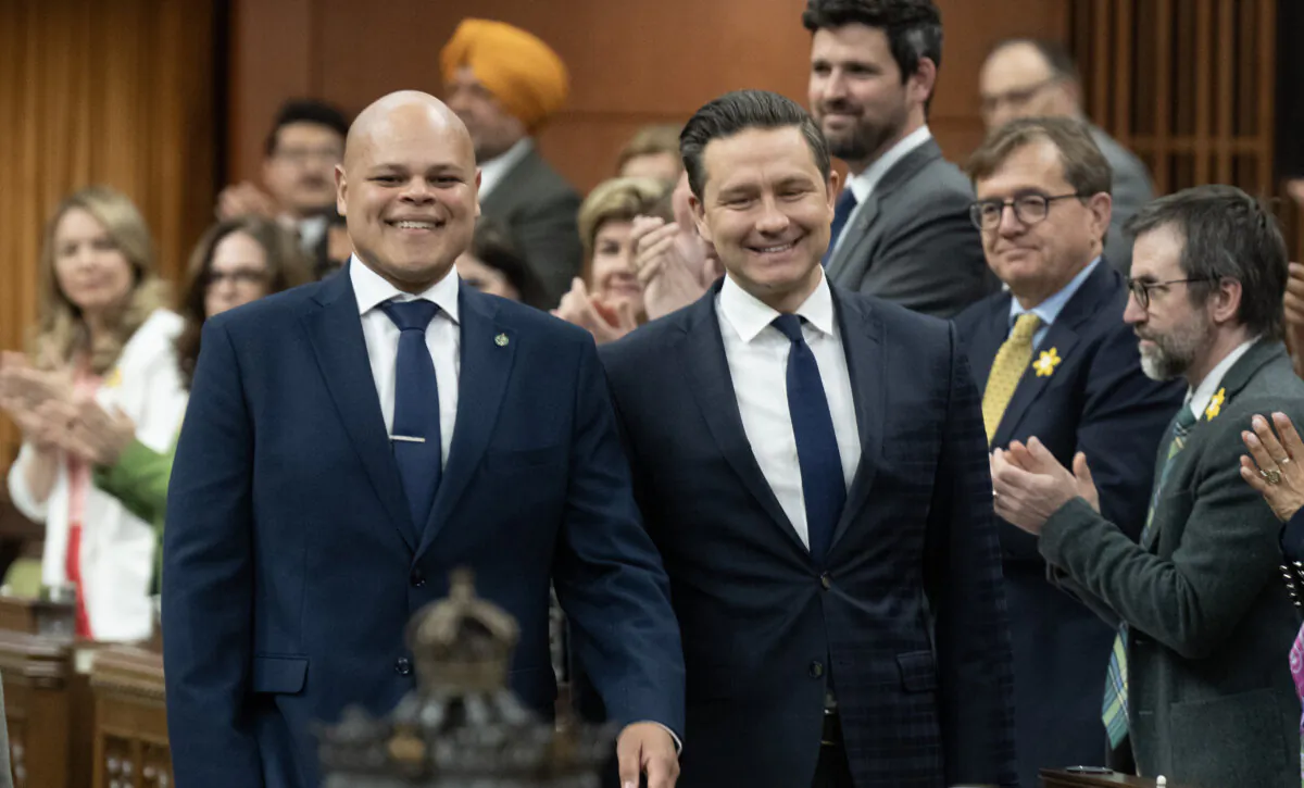 Leader of the Conservative Party Pierre Poilievre walks with new member of Parliament for Durham Jamil Jivani as he takes his place in the House of Commons before Question Period on April 8, 2024, in Ottawa. (The Canadian Press/Adrian Wyld) 