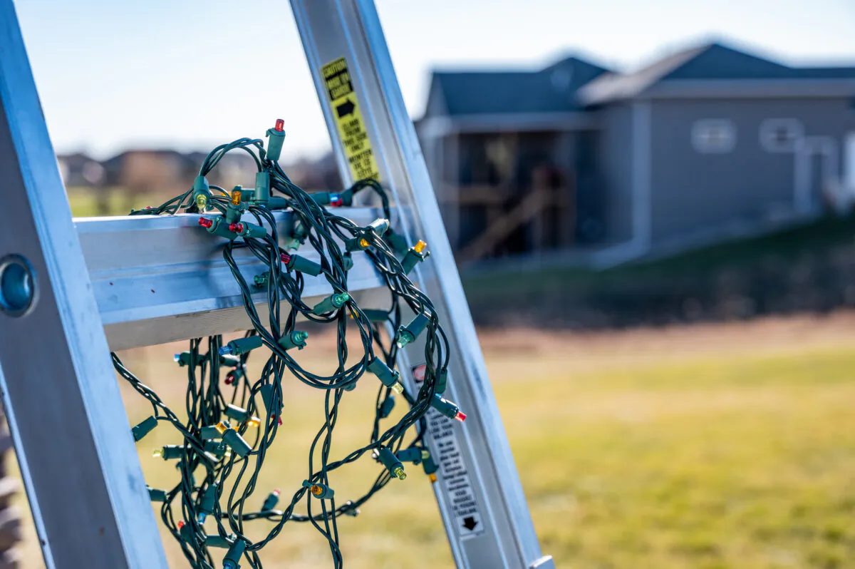 If you’re putting up lights yourself with a ladder, be sure to observe all ladder safety rules. (Dreamstime/TNS)