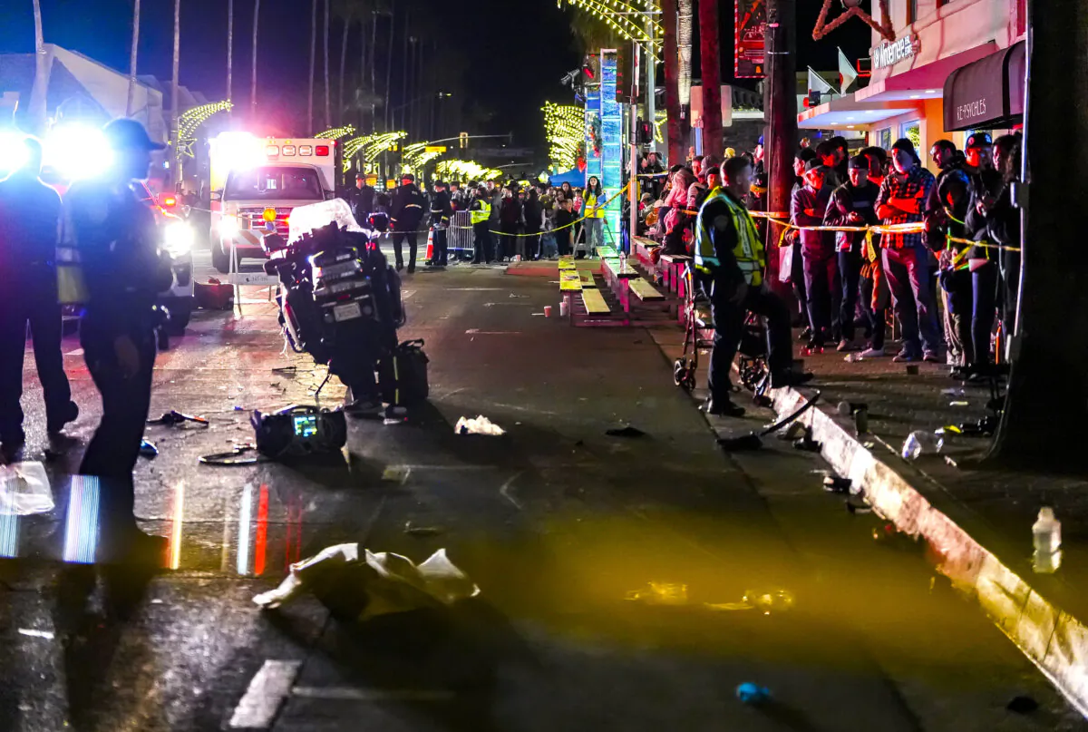 Emergency crews treat patients after a Palm Springs Police motorcycle crashes into the crowd of spectators on North Palm Canyon Drive during the Festival of Lights Parade in Palm Springs, Calif., on Dec. 7, 2024. (Andy Abeyta/The Desert Sun via AP )