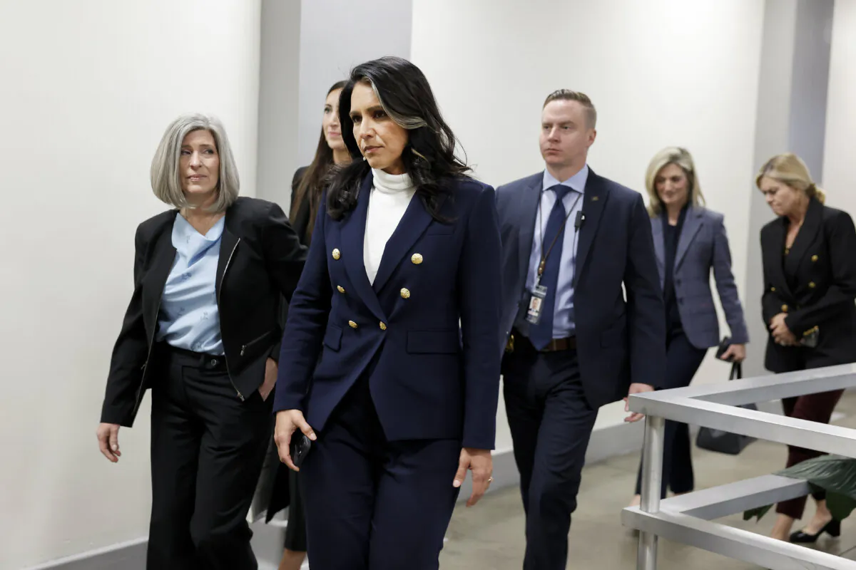 Tulsi Gabbard (C), President-elect Donald Trump's nominee to be director of national intelligence, walks with Sen. Joni Ernst (L) to the Russell Senate Office Building in Washington on Dec. 9. (Anna Moneymaker/Getty Images)