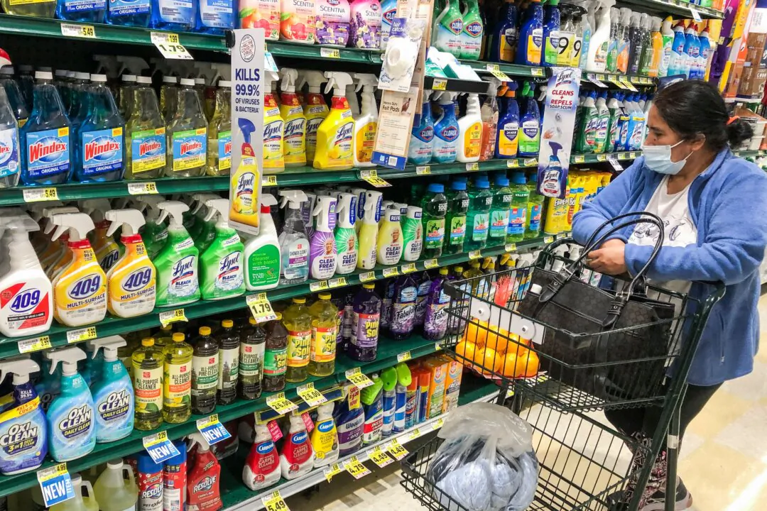 A woman looks at cleaning products as she shops in a grocery story in Arlington, Va., on Nov. 10, 2021. (Andrew Caballero-Reynolds/AFP via Getty Images)