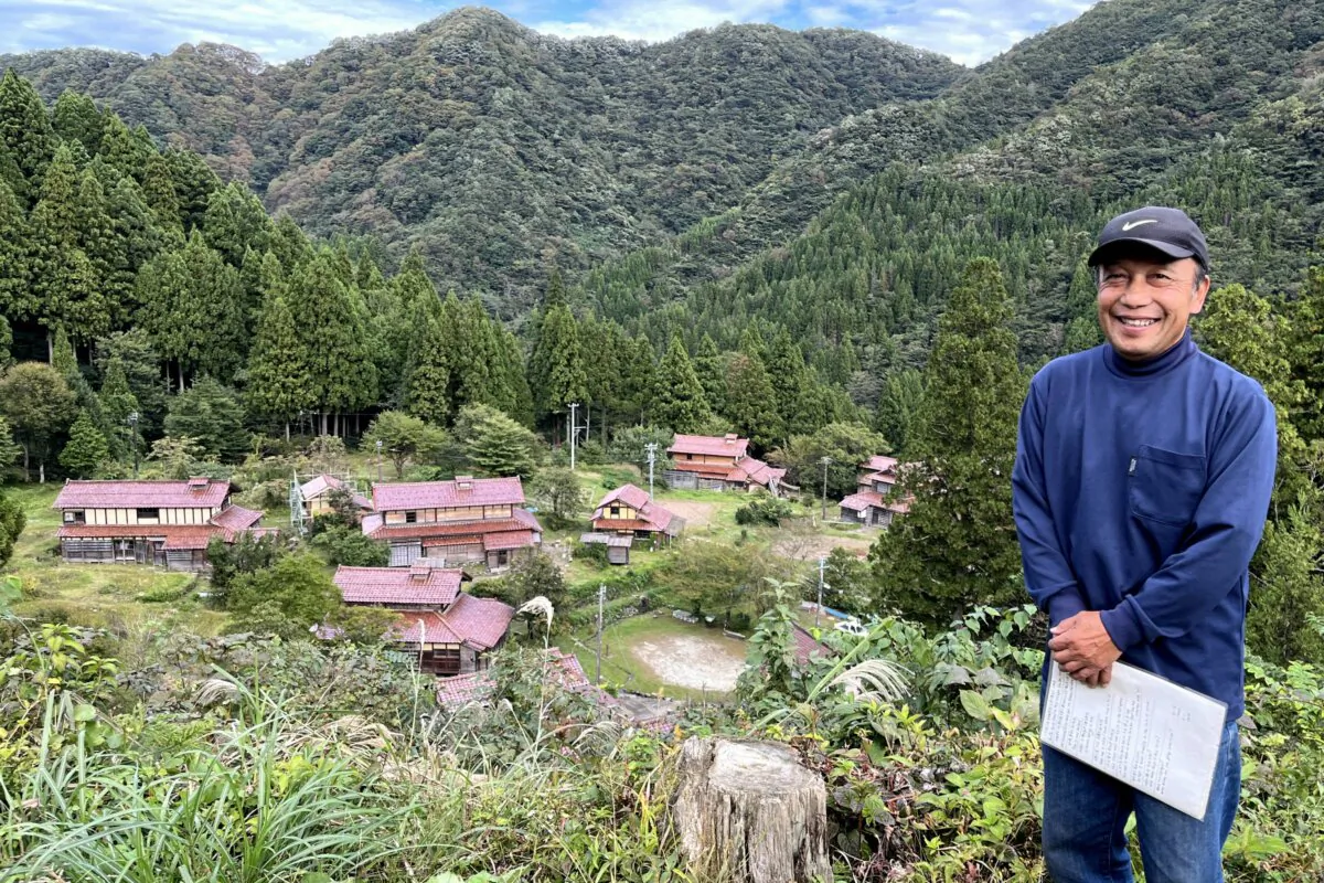 Noburu Nimaida poses with his village of Ozuchi in the background. (Courtesy of Noburu Nimaida)