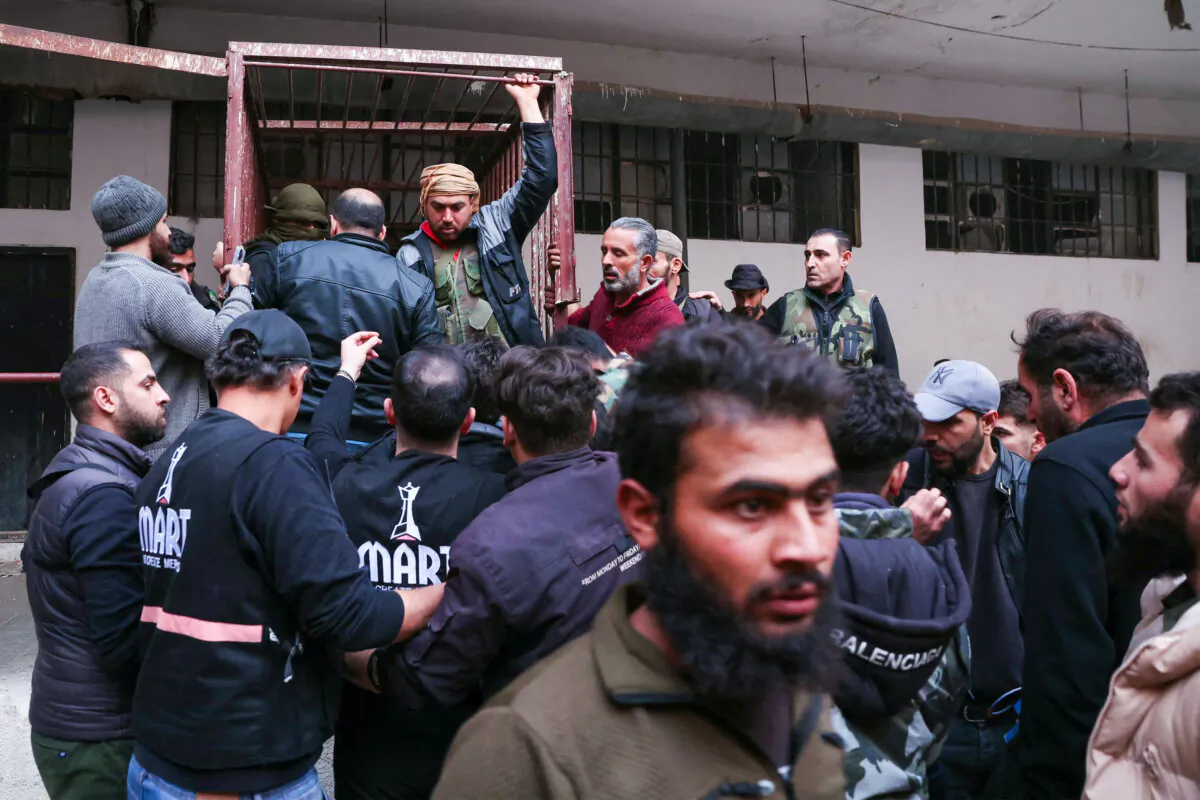 People gather at the Saydnaya prison looking for loved ones in Damascus, Syria, on Dec. 9, 2024. (OMAR HAJ KADOUR/AFP via Getty Images)