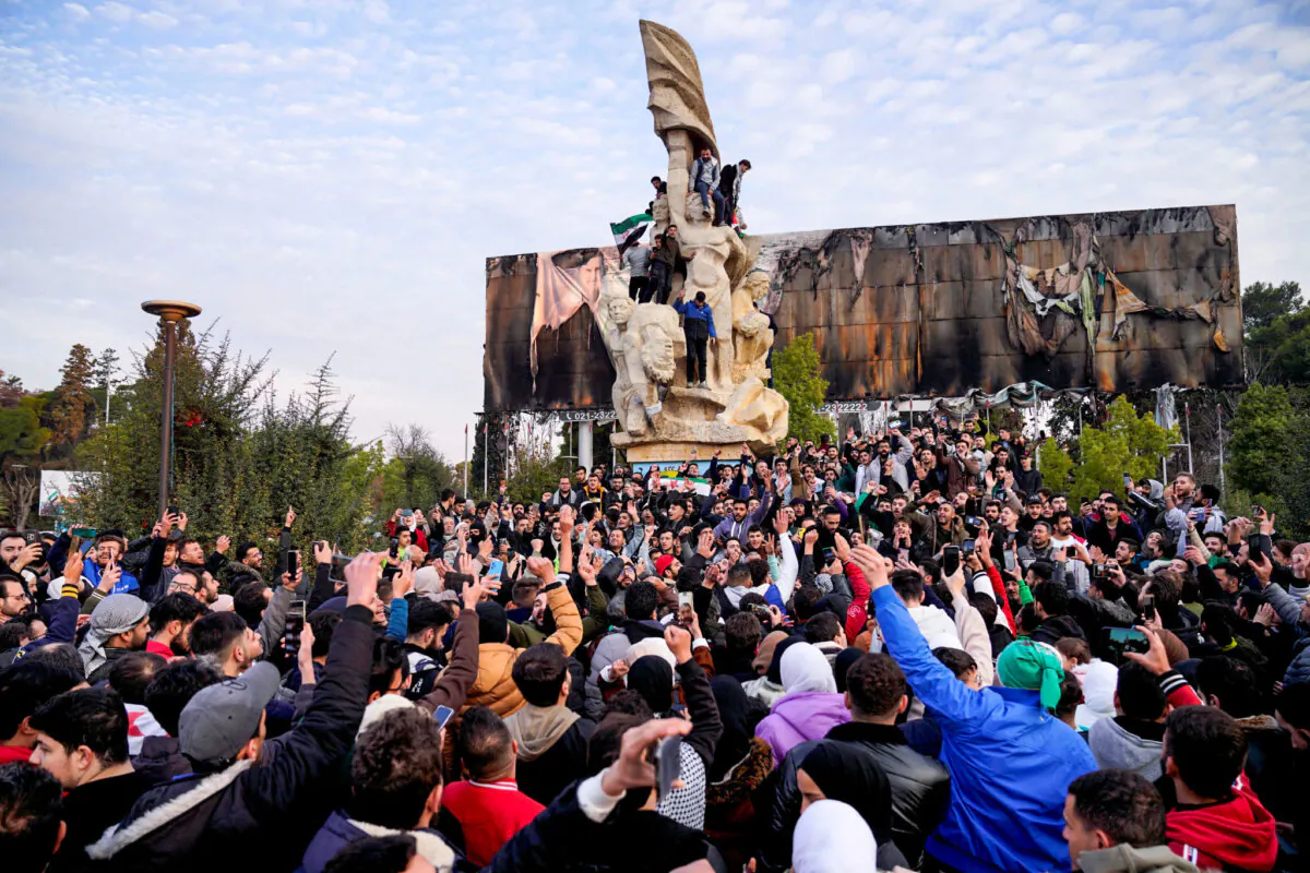 People gather at Saadallah al-Jabiri Square to celebrate, after Syria's army command notified officers on Sunday that President Bashar al-Assad's rule has ended, in Aleppo, Syria, on Dec. 8, 2024. (Karam al-Masri/Reuters)