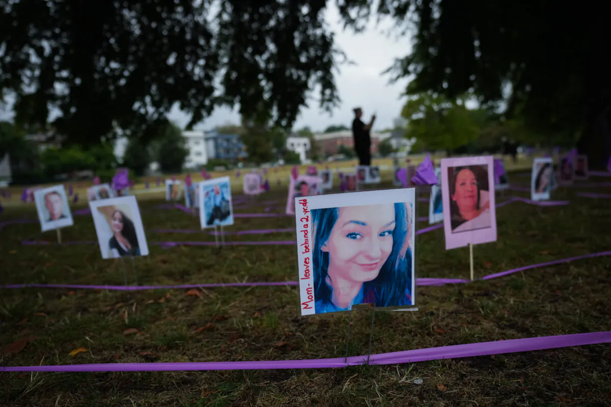Photographs of overdose victims are displayed as members of Moms Stop the Harm mark International Overdose Awareness Day, in Vancouver, B.C., on Aug. 31, 2023. (The Canadian Press/Darryl Dyck) 