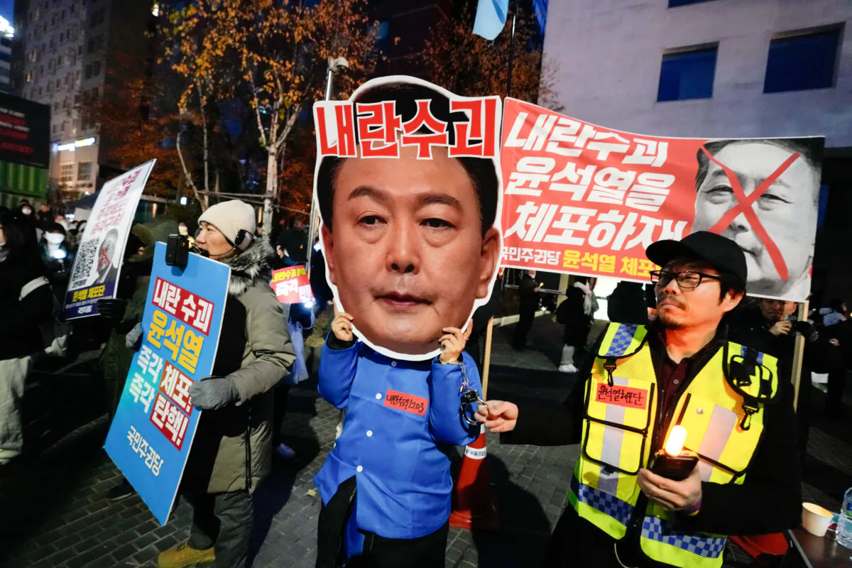 A participant wearing a mask of South Korean President Yoon Suk Yeol attends a rally demanding his impeachment, outside the National Assembly in Seoul, South Korea, on Dec. 8, 2024. (Ahn Young-joon/AP Photo)