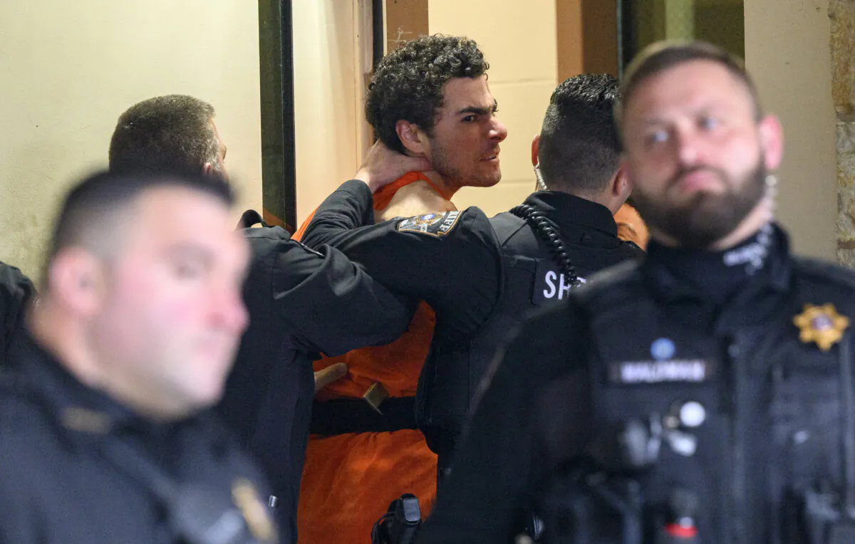 Suspected shooter Luigi Mangione is led into the Blair County Courthouse for an extradition hearing in Hollidaysburg, Pa., on Dec. 10, 2024. (Jeff Swensen/Getty Images)