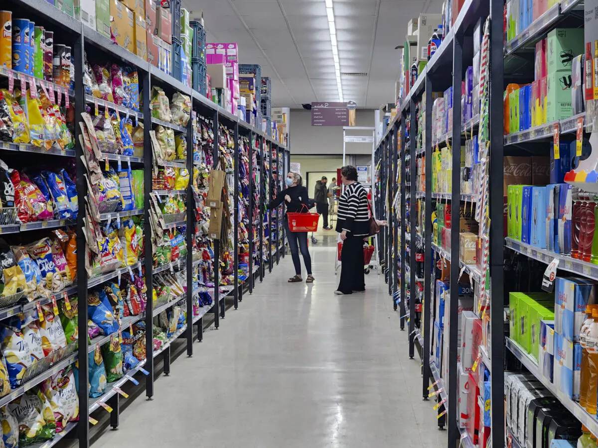 People shop in the confectionery section of a supermarket in Western Australia on May 4, 2024. (Susan Mortimer/The Epoch Times)