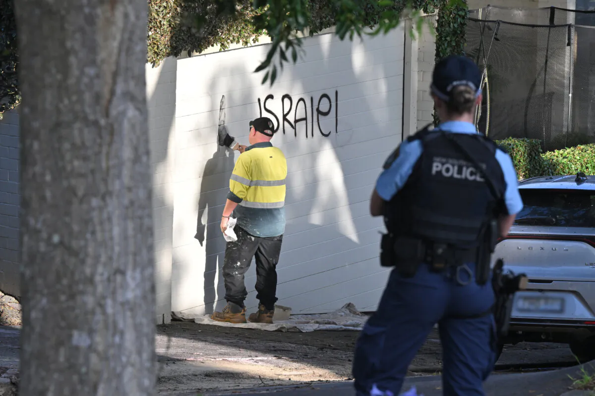 A contractor cleans anti-Israel graffiti on Magney St, Woollahra in Sydney, Australia, on Dec. 11, 2024. (AAP Image/Mick Tsikas)