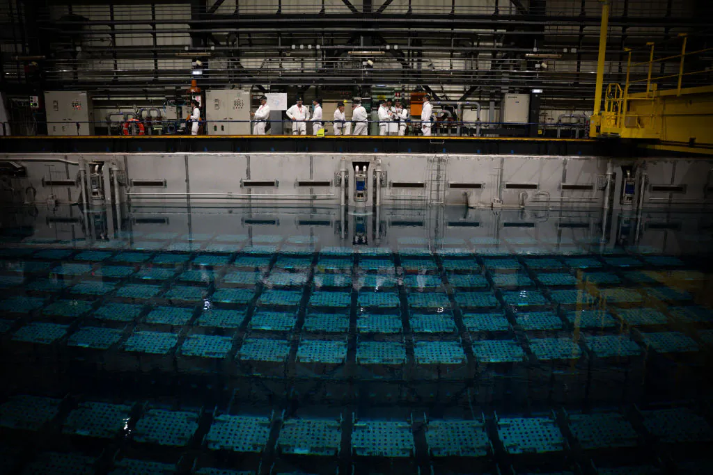 Journalists stand in front of a nuclear spent fuel pool in La Hague, northwestern France, on Aug. 29, 2024. (Lou Benoist/AFP via Getty Images)