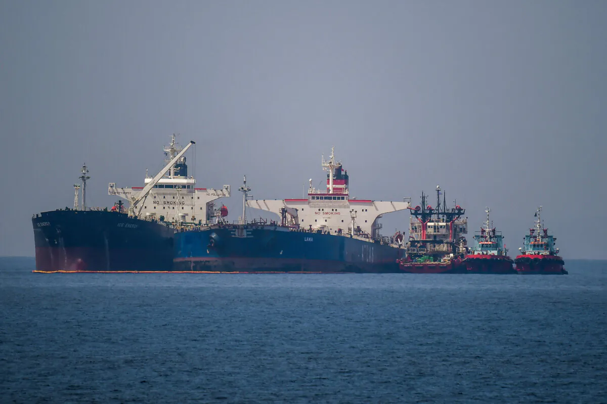 The Liberian-flagged oil tanker Ice Energy (L) transfers crude oil from the Russian-flagged oil tanker Lana (R) off the shore of Karystos, on the Greek island of Evia, on May 29, 2022. (Angelos Tzortzinis/AFP)
