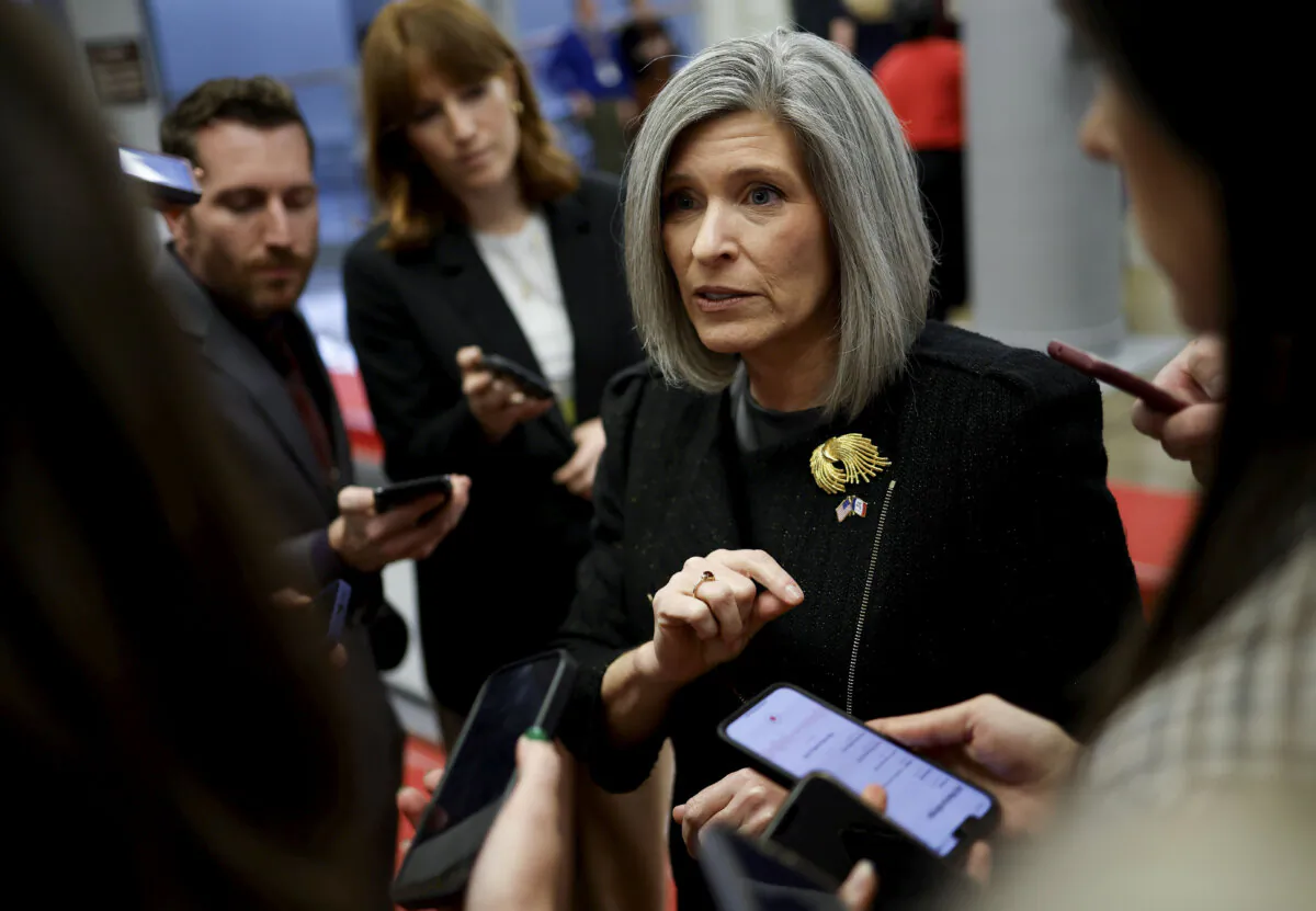 Sen. Joni Ernst (R-Iowa) speaks to reporters as she walks to a Senate luncheon at the U.S. Capitol in Washington on Nov. 19, 2024. (Kevin Dietsch/Getty Images)