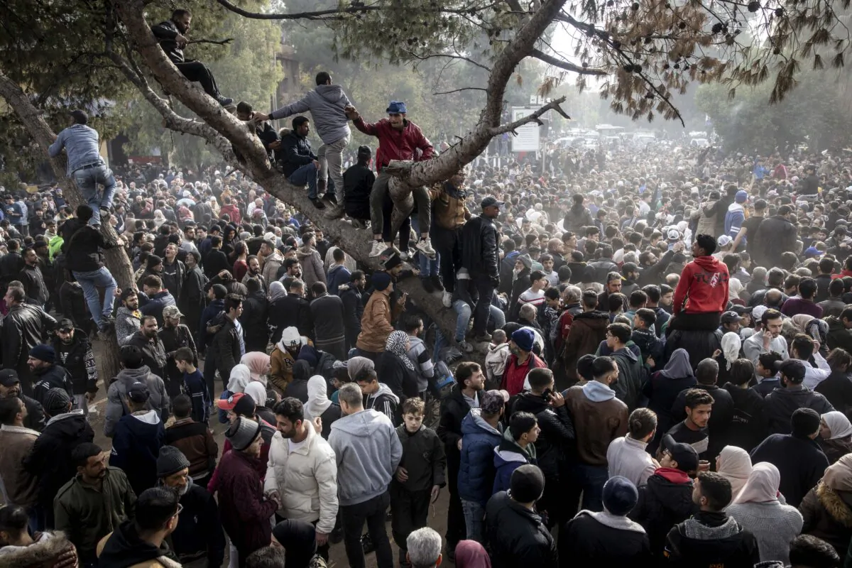 People gather in Al-Madan Square to call for accountability of war crimes committed by the Syrian Armed Forces under the Assad regime, in Madaya, Syria, on Dec. 11, 2024. (Chris McGrath/Getty Images)