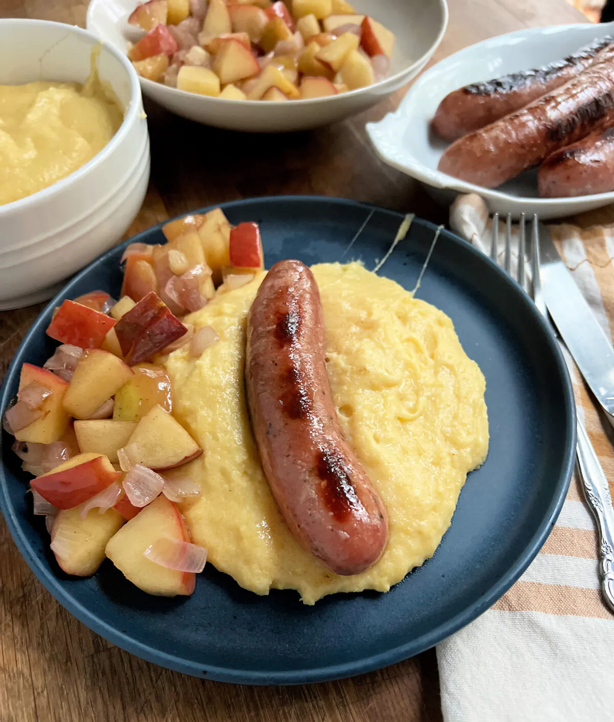 Apple sausage and sauteed apples on a bed of cheesy polenta is a quick mid-week autumn meal. (Gretchen McKay/Pittsburgh Post-Gazette/TNS)