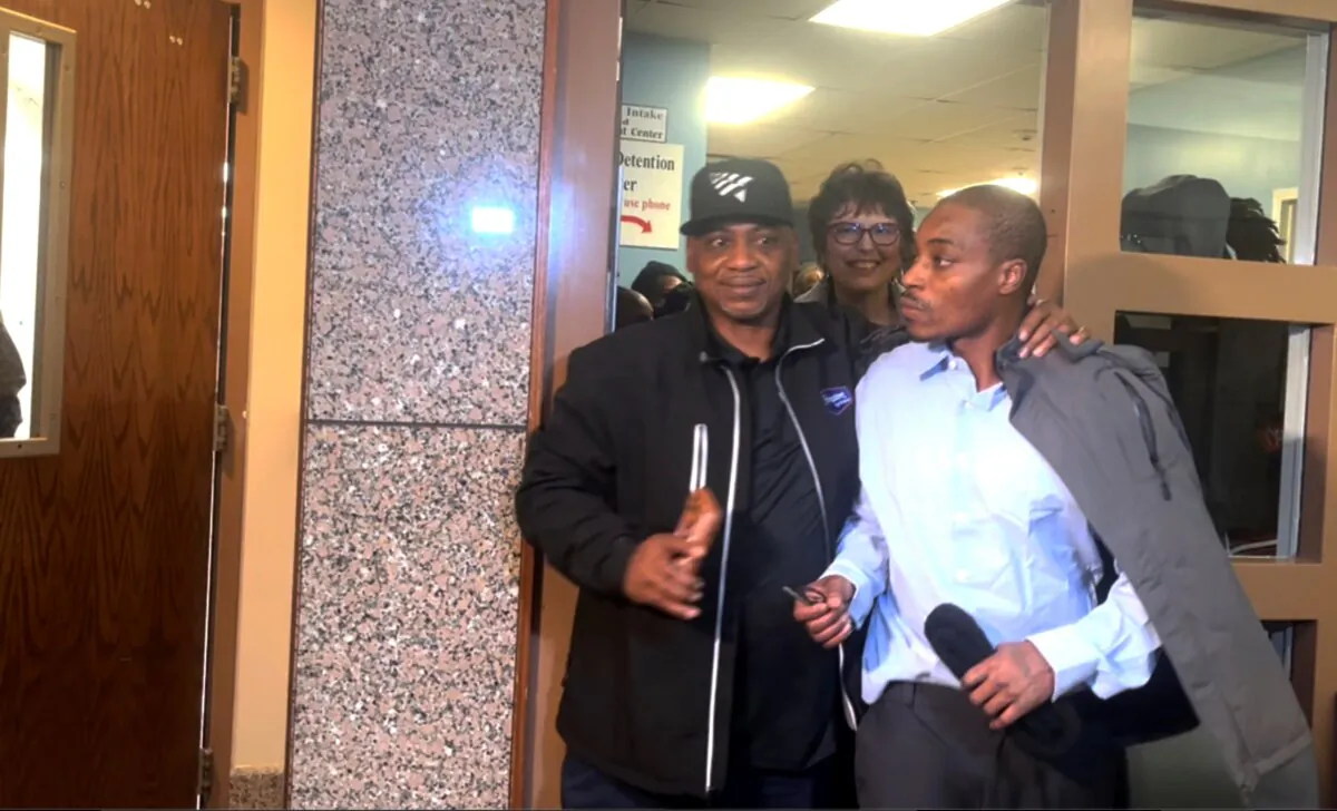 In this image taken from video, Cedric Warren (R), walks out of the Wyandotte County Courthouse in Kansas City accompanied by his father, after his conviction was overturned, Kan., on Dec. 11, 2024. (Heather Hollingsworth/AP Photo)