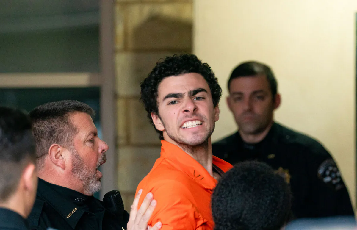 Suspect Luigi Mangione is taken into the Blair County Courthouse in Hollidaysburg, Pa., on Dec. 10, 2024. (Benjamin B. Braun/Pittsburgh Post-Gazette via AP)