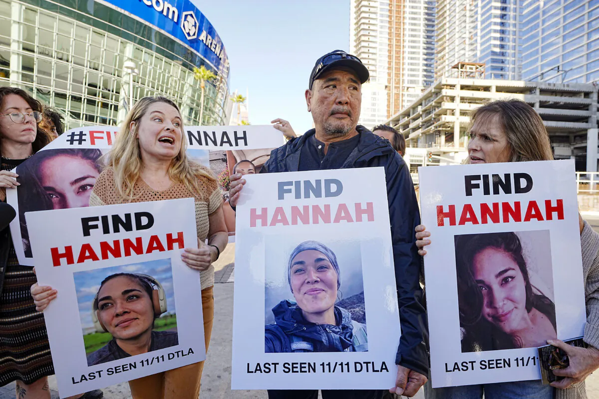 Ryan Kobayashi (C) holds a picture of his missing daughter Hannah Kobayashi outside Crypto.com Arena in Los Angeles on Nov. 21, 2024. (Damian Dovarganes/AP Photo)