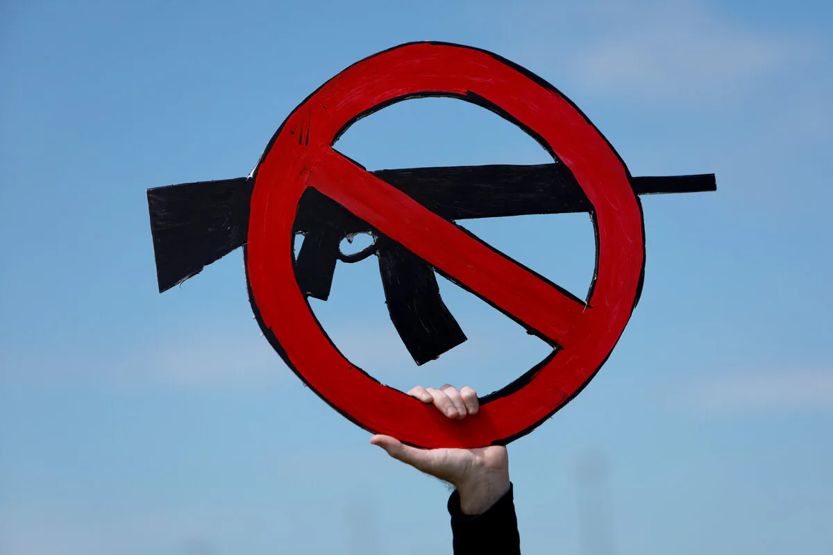 A man holds a sign during the second March for Our Lives rally against violence using guns at Pine Trails Park, in Parkland, Fla., on June 11, 2022. (Joe Raedle/Getty Images)