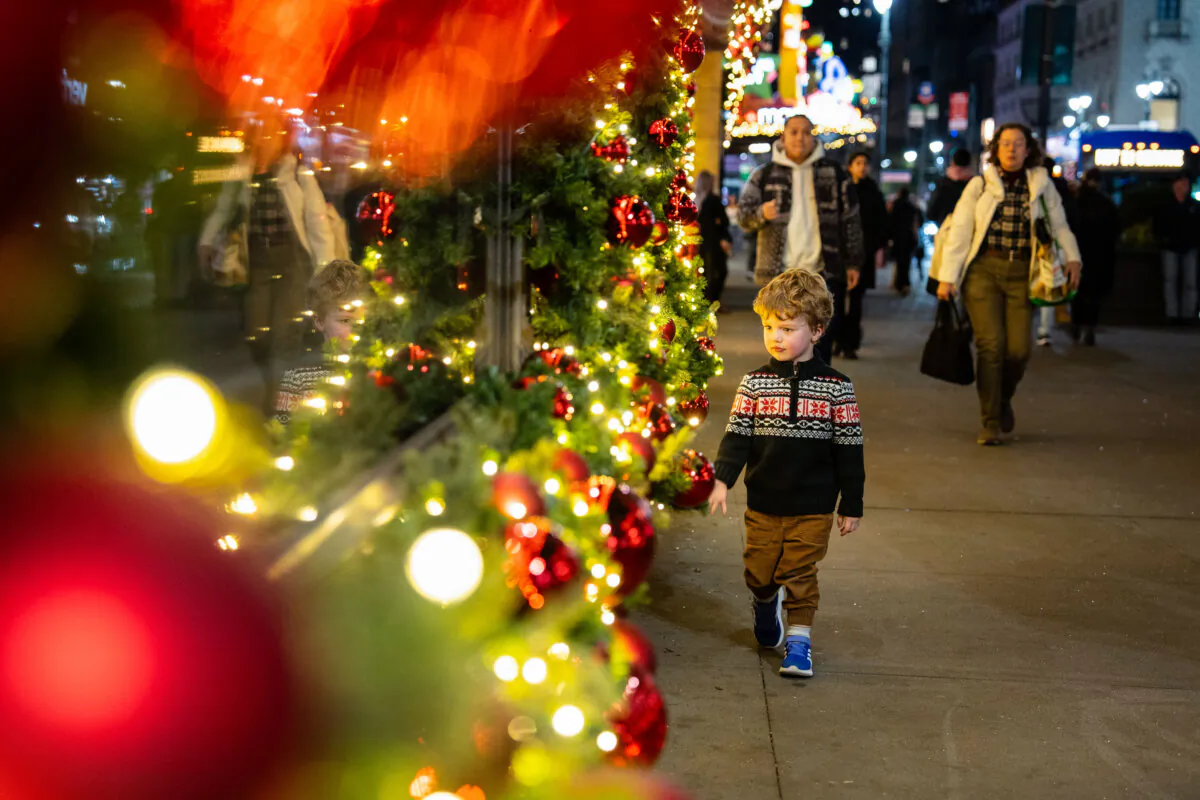 A boy looks at holiday decorations in New York City on Nov. 15, 2024. (Samira Bouaou/The Epoch Times)
