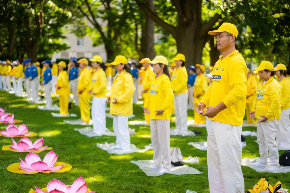 Falun Gong practitioners perform the exercises at a rally commemorating the 25th anniversary of the persecution of Falun Gong in China, in downtown Toronto, Canada, on July 20, 2024. (Evan Ning/The Epoch Times)