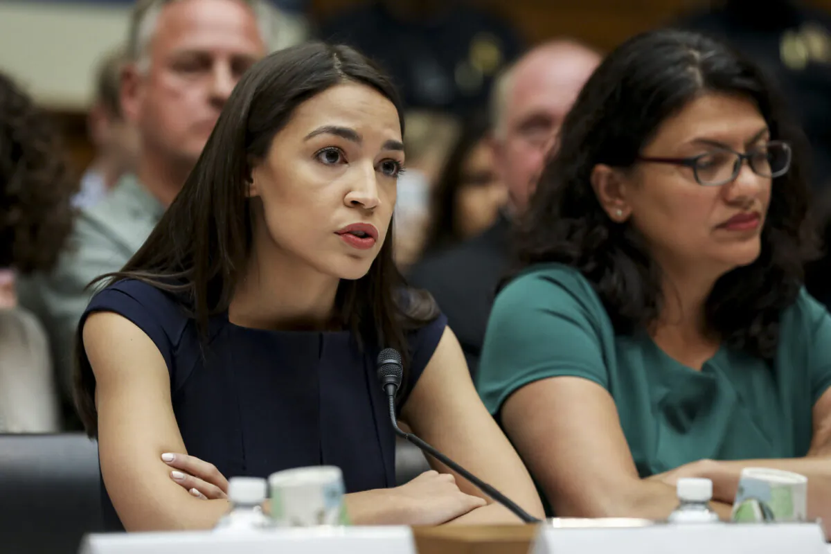 (L–R) Rep. Alexandria Ocasio-Cortez (D.N.Y.) and Rashida Tlaib (D-Mich.), members of the Democratic Socialists of America, at a House hearing in front of the Committee on Oversight and Reform in Washington on July 12, 2019. (Charlotte Cuthbertson/The Epoch Times)