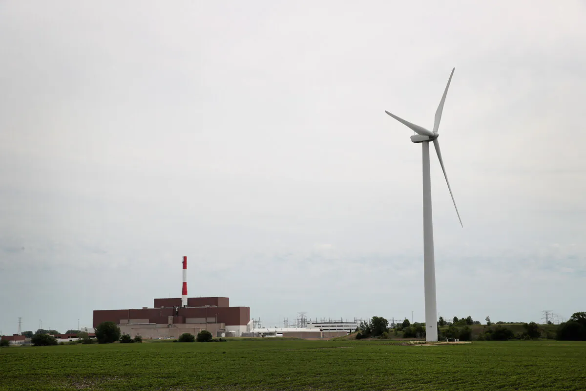 A power generating windmill towers above a nuclear power plant operated in Marseilles, Illinois, on June 14, 2018. (Scott Olson/Getty Images)