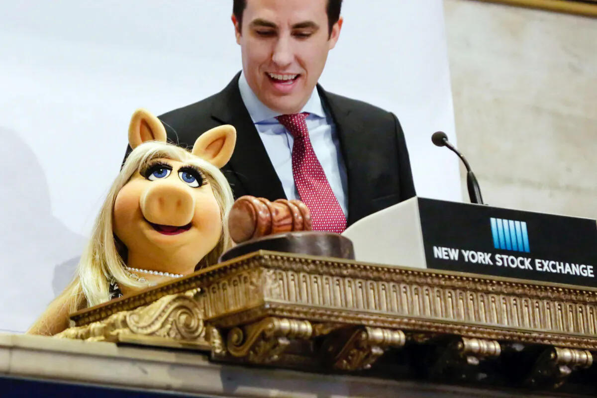 Miss Piggy, with New York Stock Exchange Chief of Staff John Tuttle, rings the NYSE opening bell to highlight the season premier of Disney's "The Muppets" television show, on Feb. 1, 2016. (Richard Drew/AP Photo)