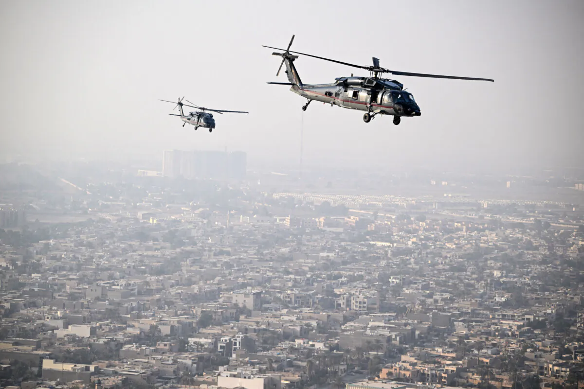 US State Department Sikorsky HH-60L Black Hawk helicopters fly over Baghdad towards the US embassy headquarters on Dec. 13, 2024. (Andrew Caballero-Reynolds/POOL/AFP via Getty Images)